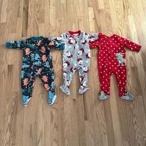 Three Carter’s fleece footie pajamas 12 months. Christmas reindeer Santa monster